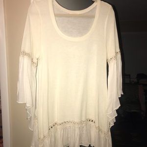 Cream top with cut outs on sleeves
